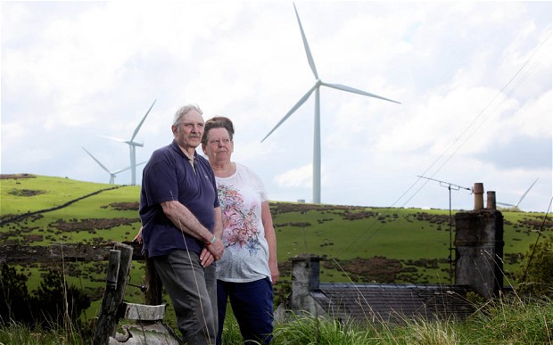 John and kay Siddell by their home, which now looks over to turbines